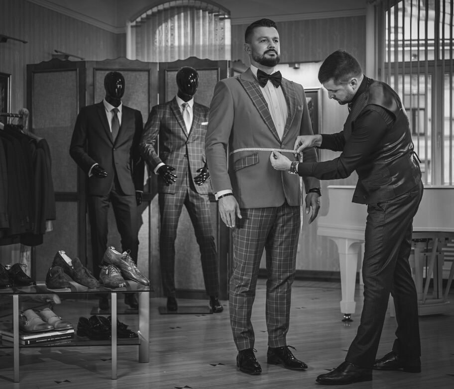 Tailor Measuring Client for Custom Made Suit Tailoring