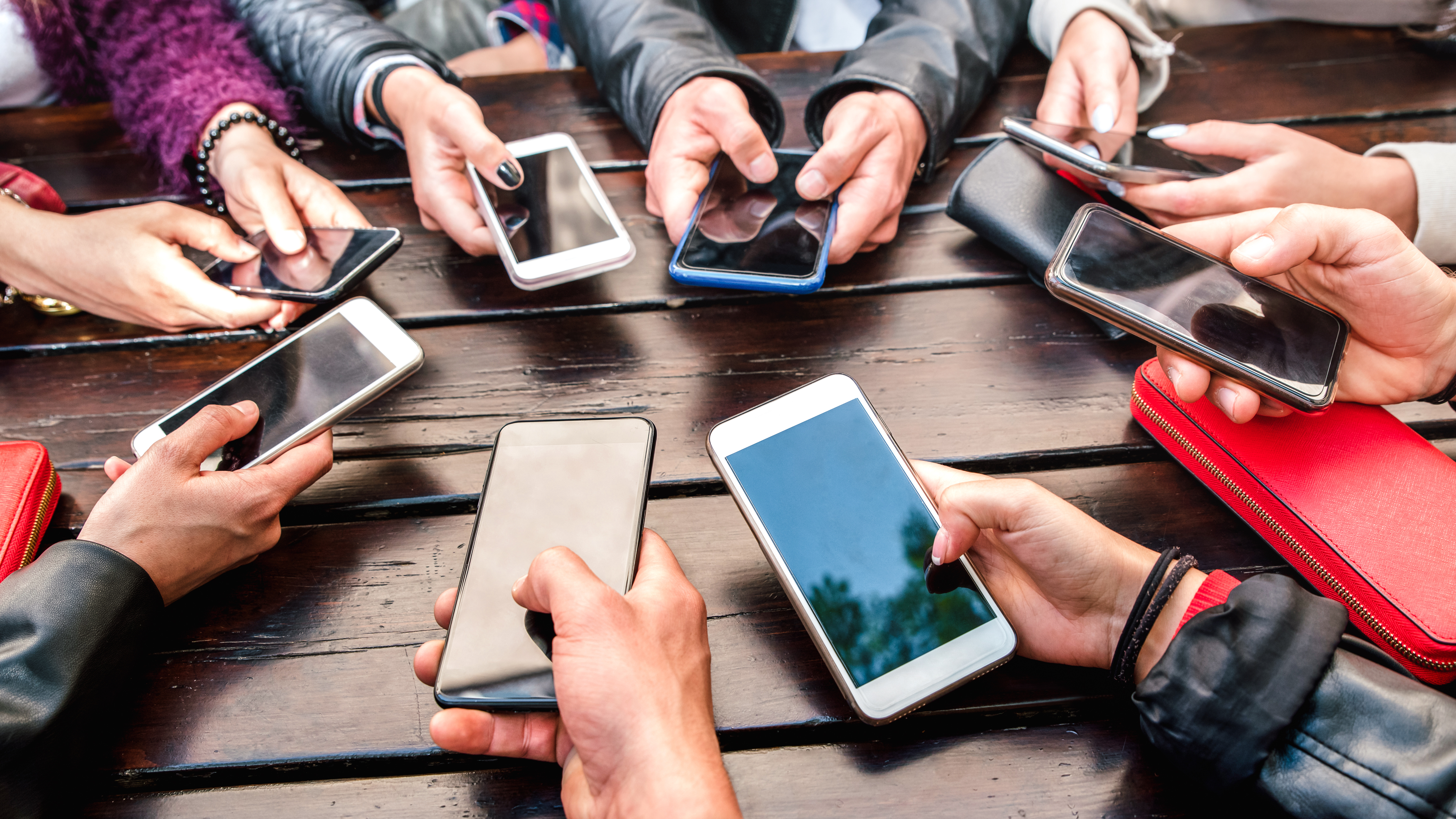 Milenial People Having Fun Using Smart Phones - Gen Z Community